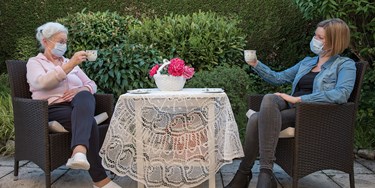 Covid - meeting a bubble in garden wearing masks and drinking tea