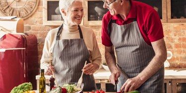 Couple preparing fresh salad
