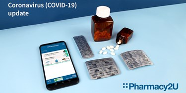 Pills on a table next to mobile phone