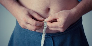 Man measuring his waist