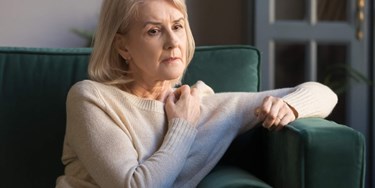 Woman on sofa looking concerned