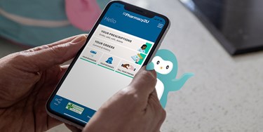 Wysa mascot waving behind man holding mobile phone with Pharmacy2U app