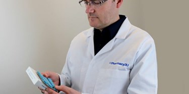 Superintendent Pharmacist Phil Day checking a pack of tablets