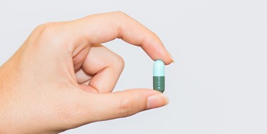 Hand holding pill