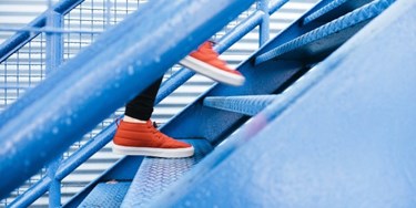 Close up on feet of person climbing stairs