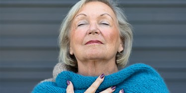 Woman In Blue Scarf Taking A Deep Breath